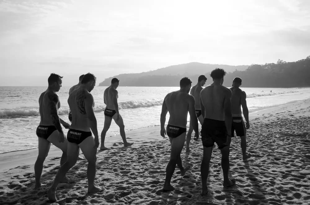 A group of coaches walking on the beach
