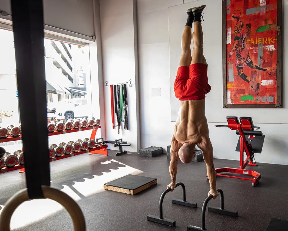 Coach performing a handstand push-up