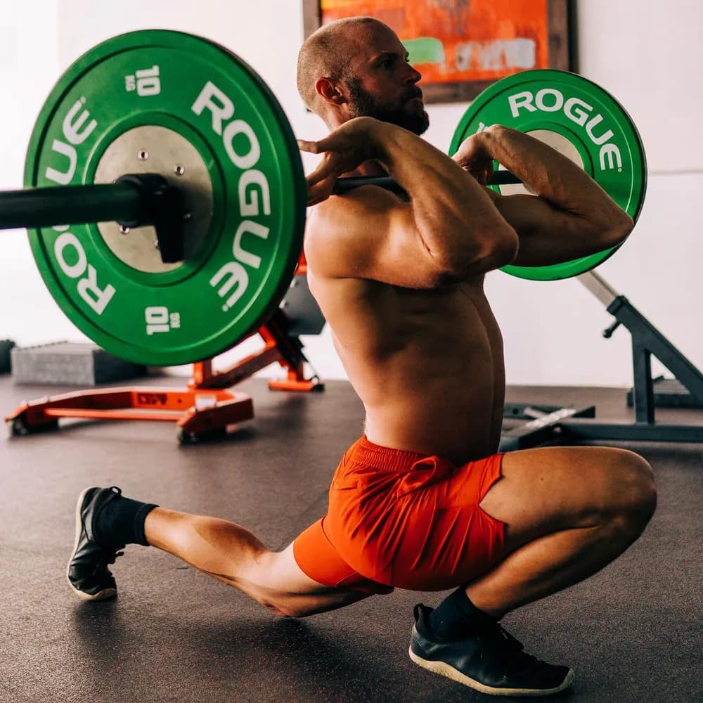 Coach performing a weighted split squat